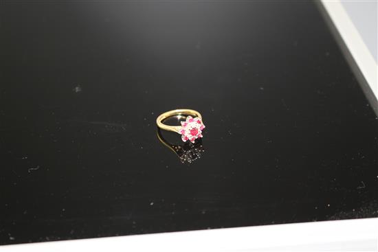 A modern 18ct gold, ruby and diamond set flower head cluster ring, size I, gross weight 3.7 grams.